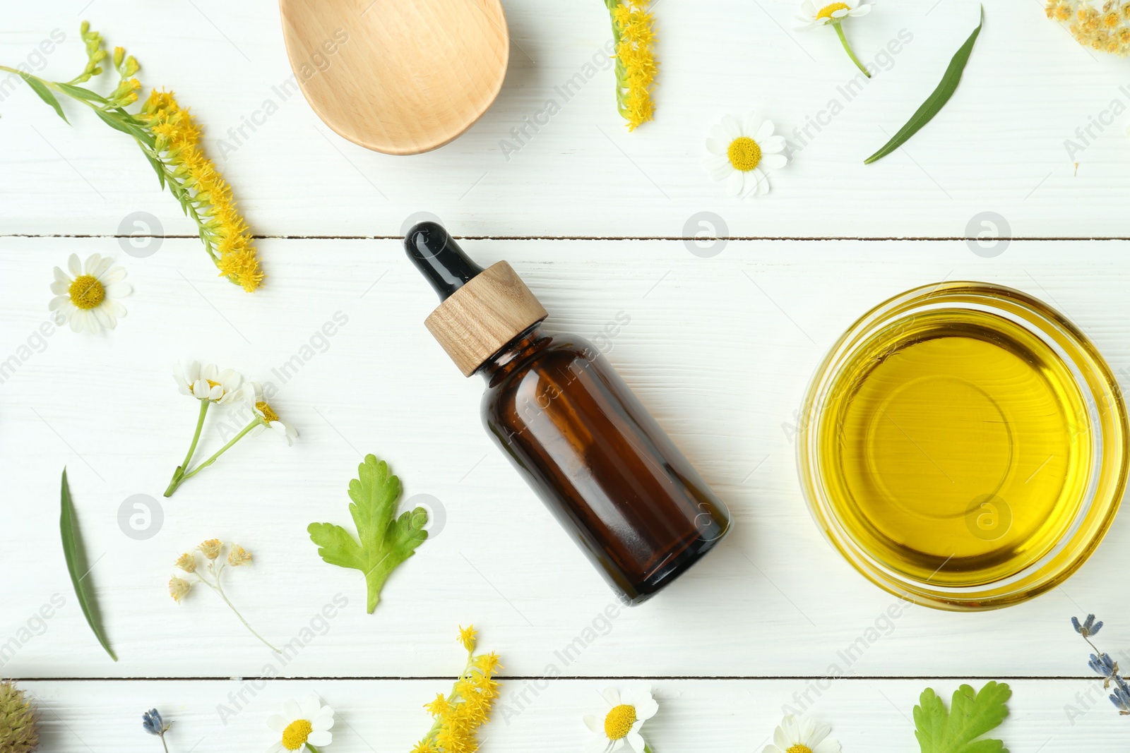 Photo of Tinctures and medicinal herbs on white wooden table, flat lay