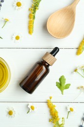 Photo of Tinctures and medicinal herbs on white wooden table, flat lay