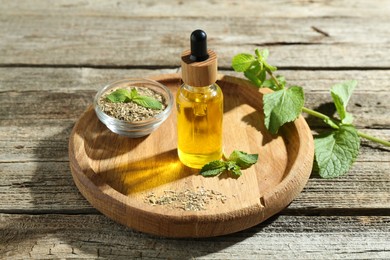 Photo of Tincture in bottle and herbs on wooden table