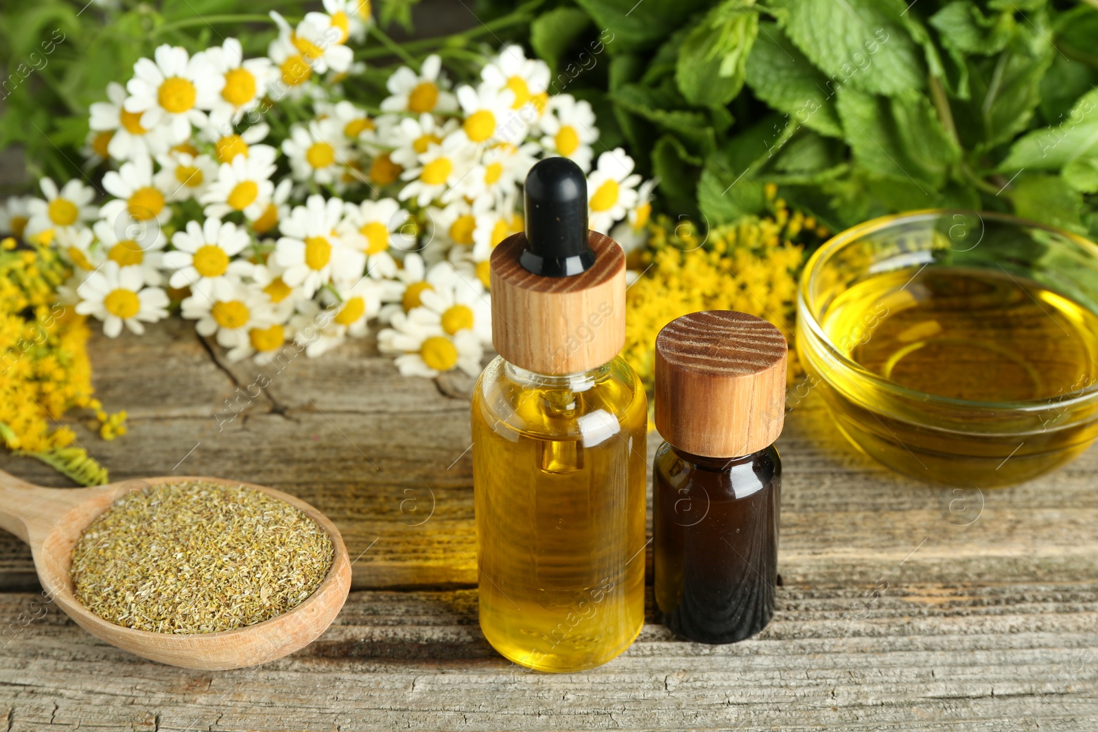 Photo of Tinctures and medicinal herbs on wooden table