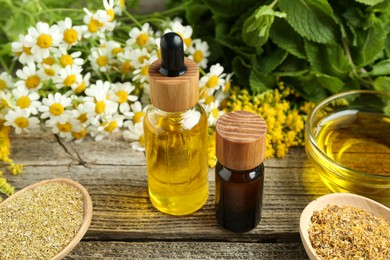 Photo of Tinctures and medicinal herbs on wooden table, closeup