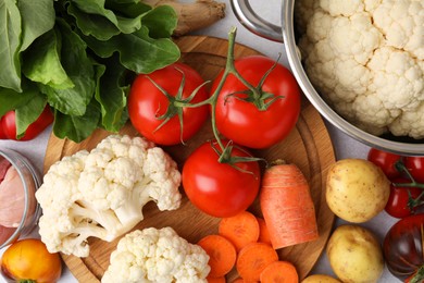 Photo of Cooking tasty stew. Different fresh vegetables on table, top view