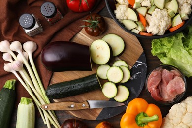 Different ingredients for stew on wooden table, flat lay