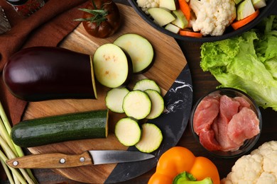 Different ingredients for stew on wooden table, flat lay