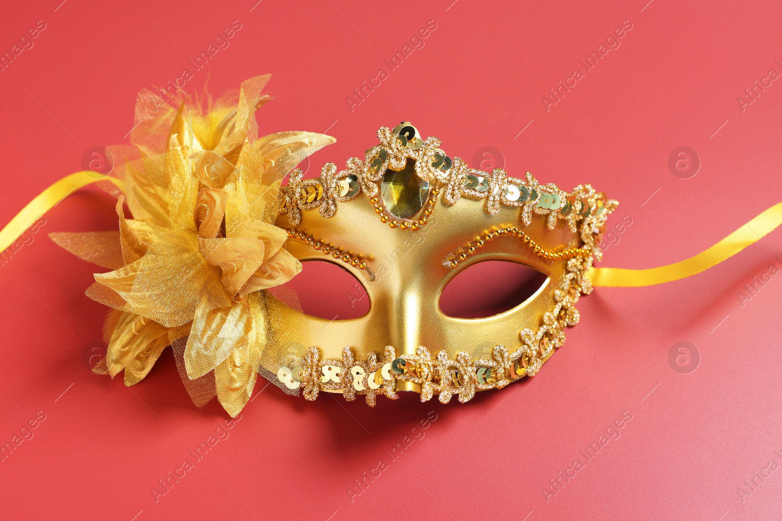 Photo of One beautiful carnival mask on red background