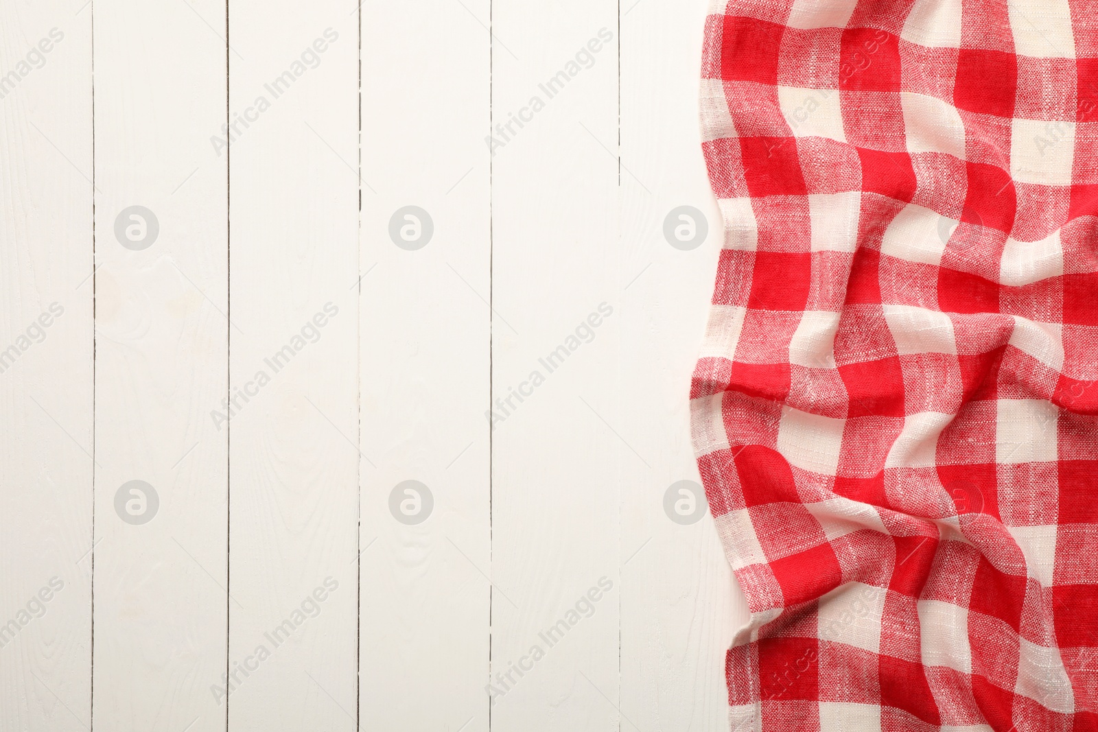 Red checkered picnic tablecloth on white wooden table, top view. Space for text Photo of Red checkered picnic tablecloth on white wooden table, top view. Space for text