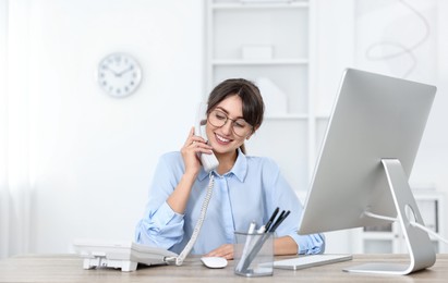 Photo of Portrait of receptionist at wooden desk in office