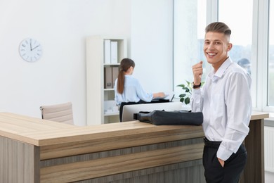 Professional receptionist and happy client in office