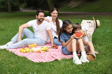 Photo of Happy family having picnic together in park