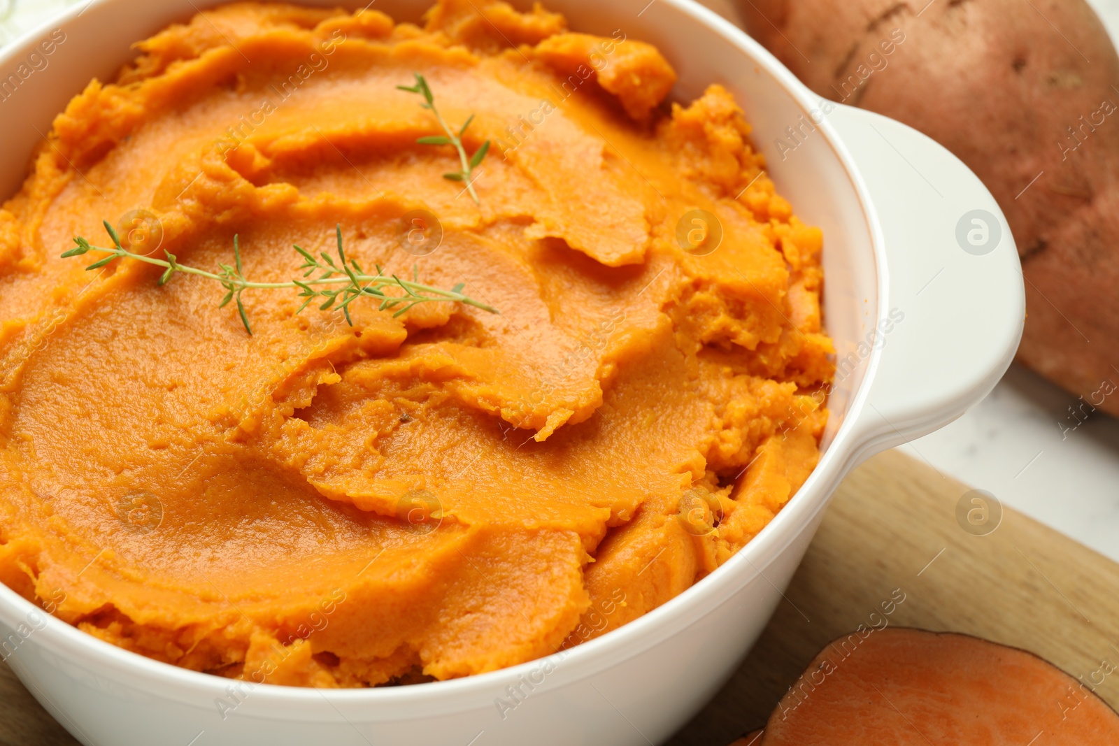 Photo of Delicious mashed sweet potatoes in pot on table, closeup