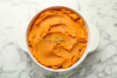 Photo of Delicious mashed sweet potatoes in pot on white marble table, top view