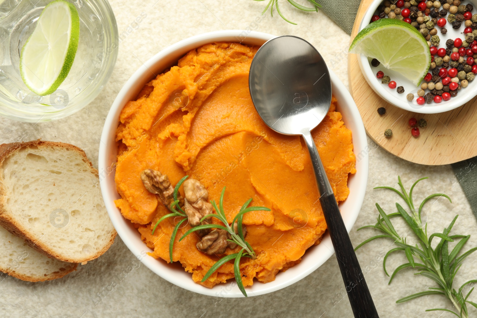 Photo of Delicious mashed sweet potatoes served on light table, top view