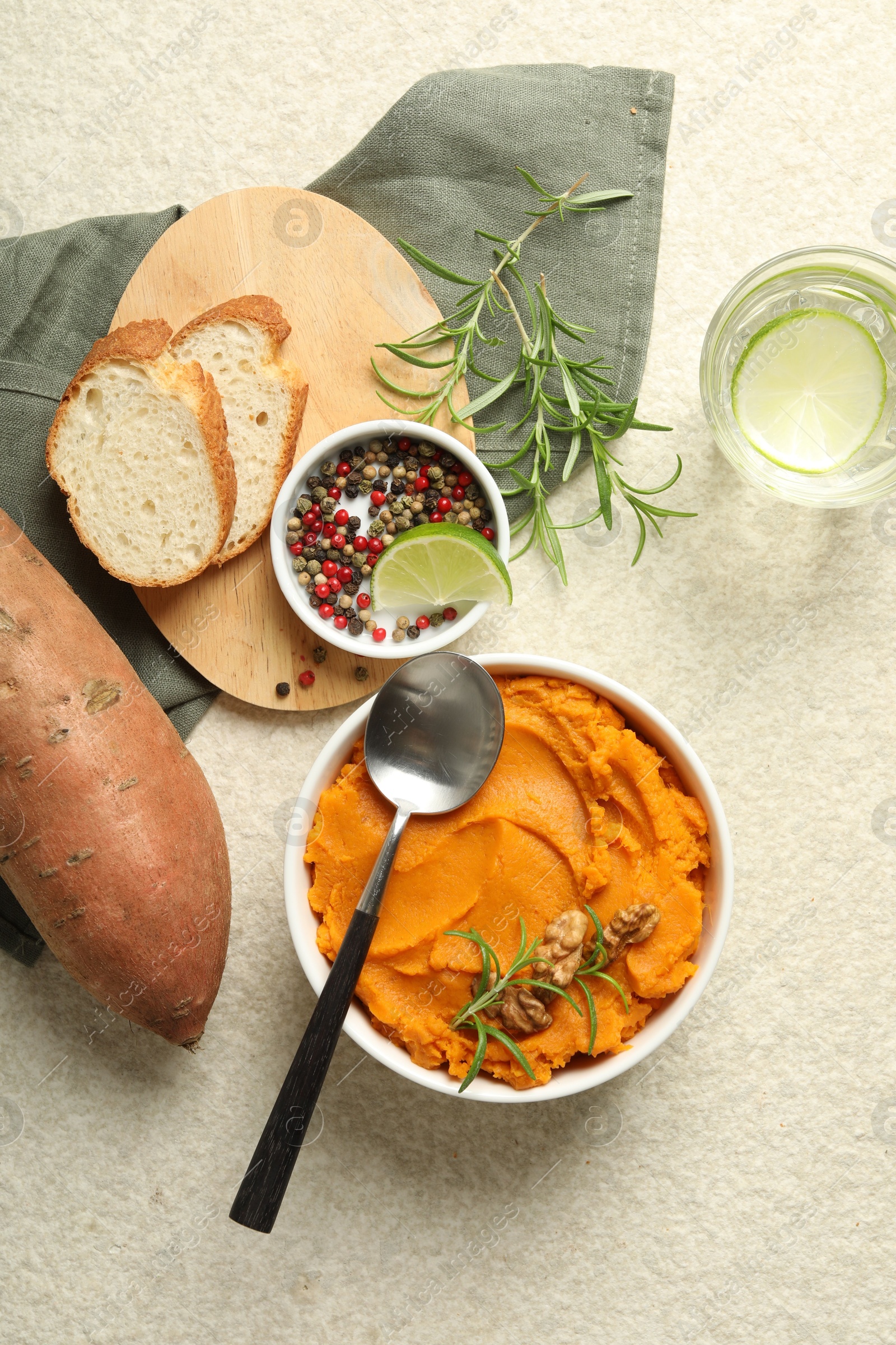 Photo of Delicious mashed sweet potatoes served on light table, top view