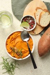 Photo of Delicious mashed sweet potatoes served on light table, top view