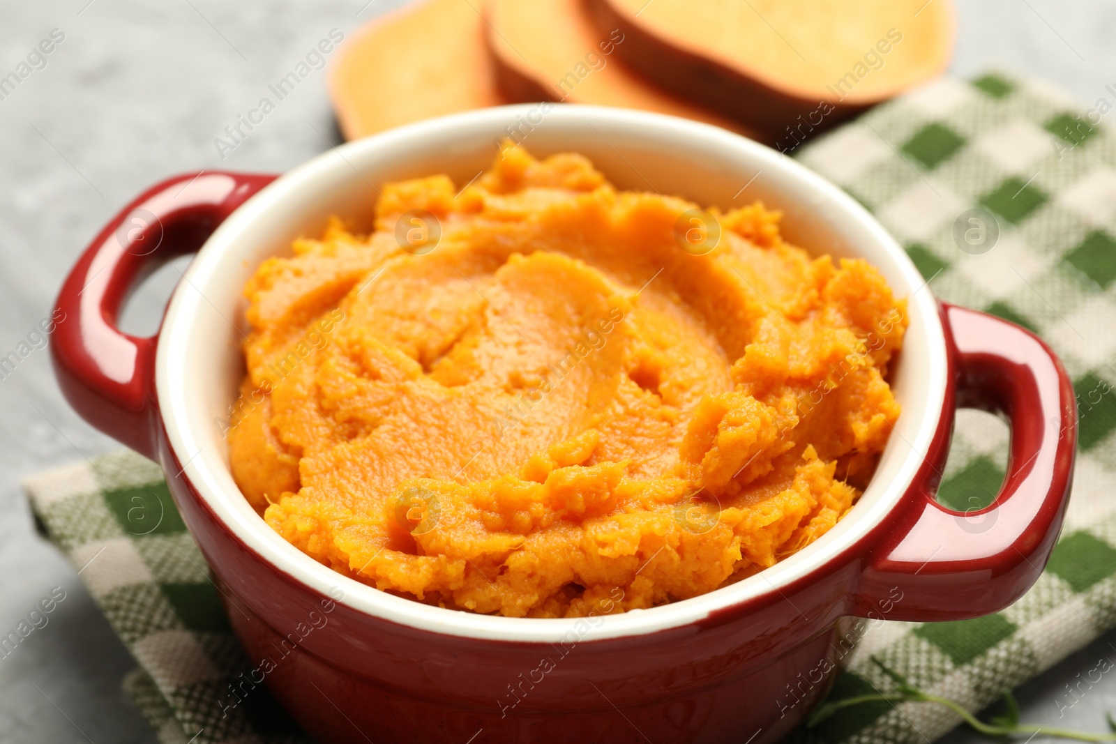 Photo of Delicious mashed sweet potatoes in pot on table, closeup