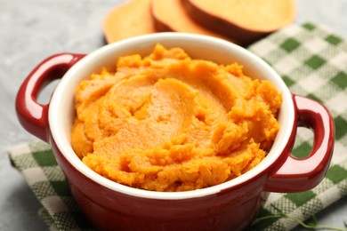 Delicious mashed sweet potatoes in pot on table, closeup