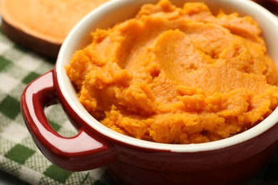 Delicious mashed sweet potatoes in pot on table, closeup