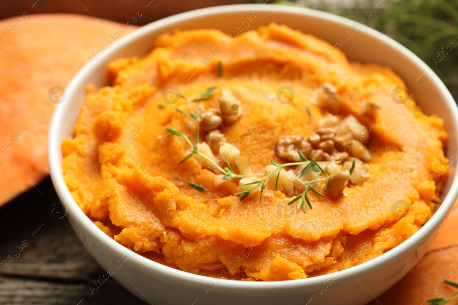 Photo of Delicious mashed sweet potatoes in bowl on table, closeup