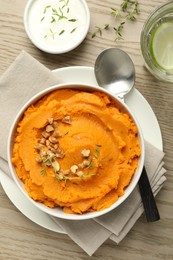 Delicious mashed sweet potatoes served on wooden table, top view