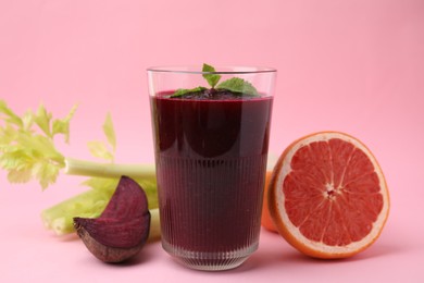 Photo of Tasty beetroot smoothie and fresh products on pink table