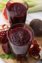 Fresh beetroot smoothie in glasses on table, closeup