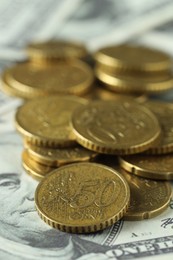 Photo of Many euro coins on dollar banknote, closeup