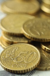 Photo of Many euro coins on dollar banknote, closeup