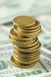 Stacked euro coins on dollar banknotes, closeup