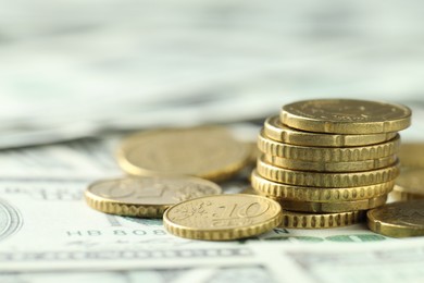 Photo of Many euro coins on dollar banknotes, closeup