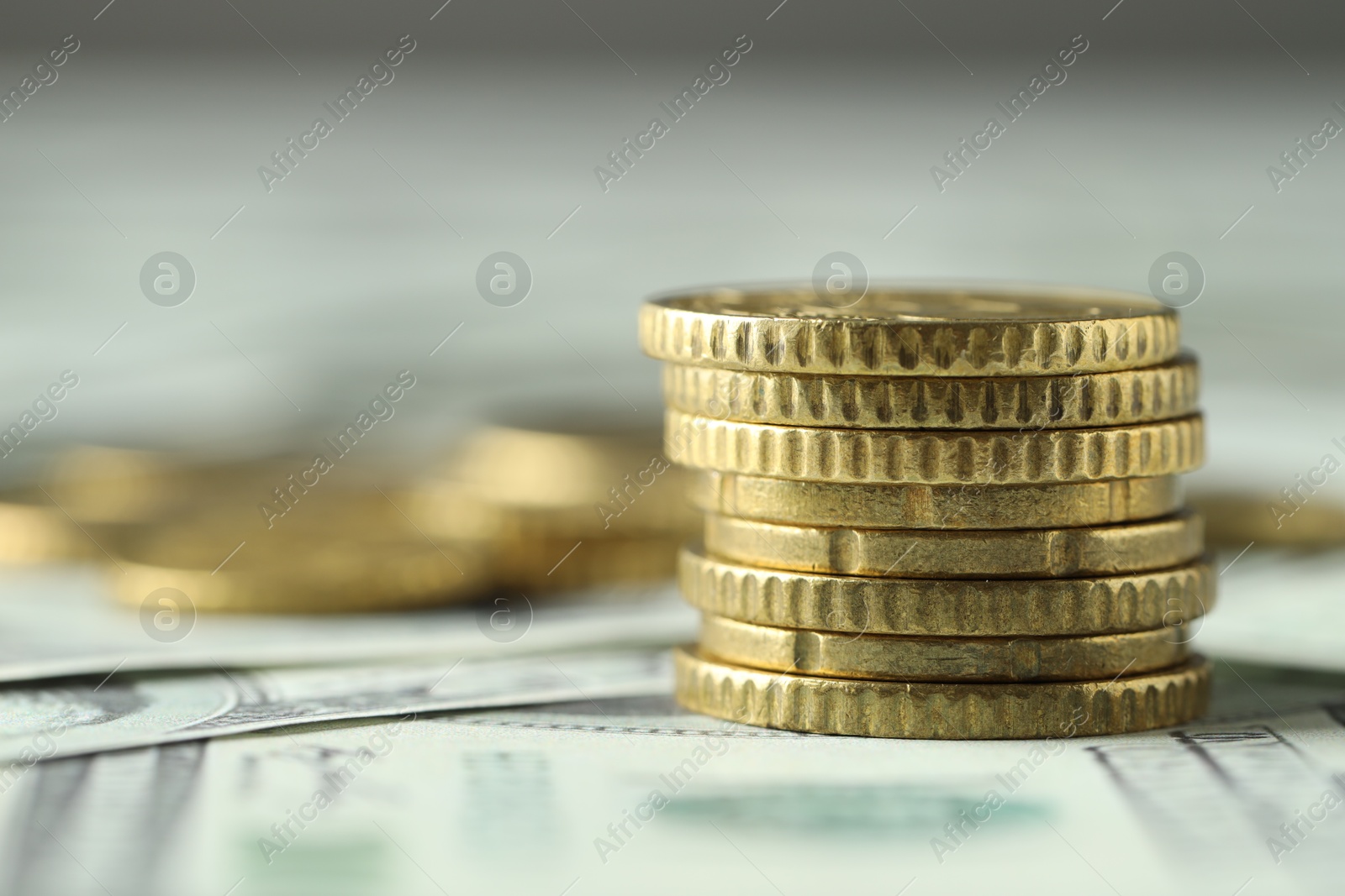 Photo of Stacked euro coins on dollar banknotes, closeup. Space for text