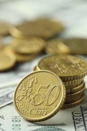 Many euro coins on dollar banknotes, closeup