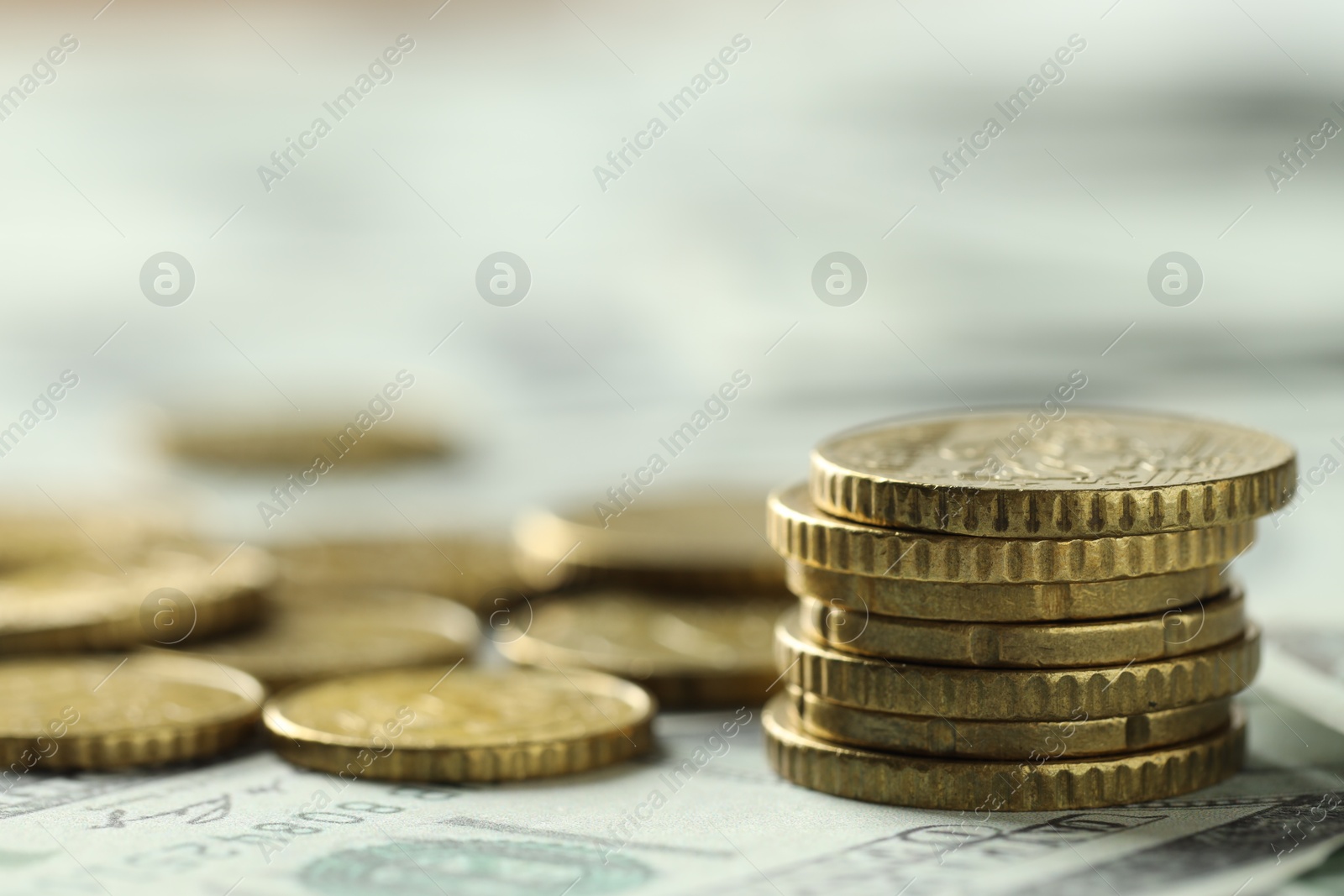 Photo of Many euro coins on dollar banknotes, closeup