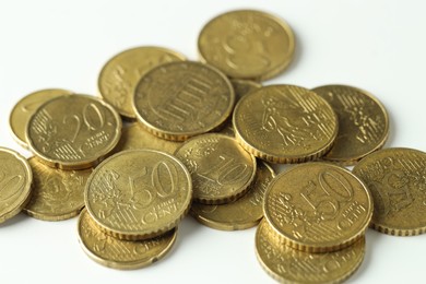 Photo of Many euro coins on white background, closeup