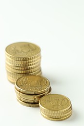 Photo of Stacked euro coins on white background, closeup