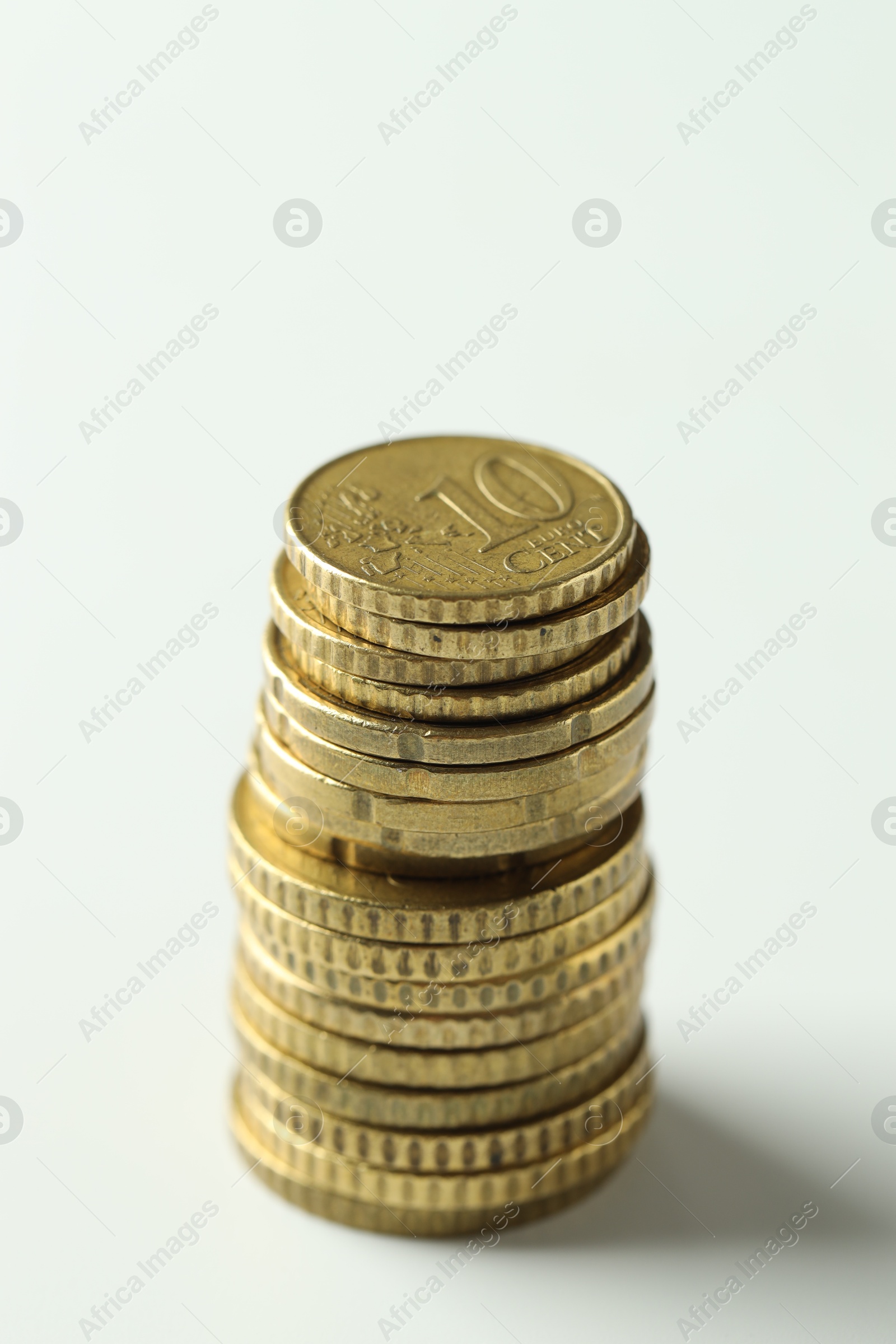 Photo of Stacked euro coins on white background, closeup