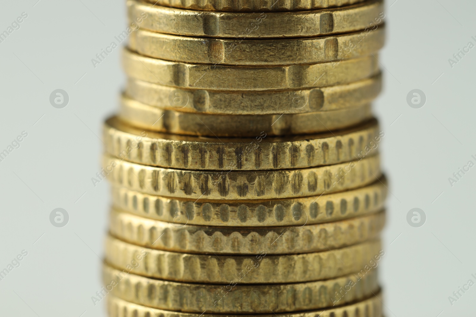 Photo of Stacked euro coins on white background, closeup