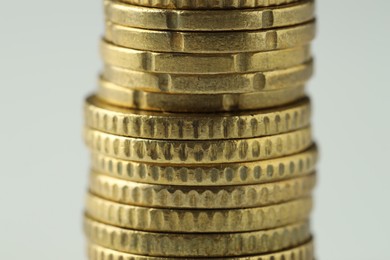 Stacked euro coins on white background, closeup