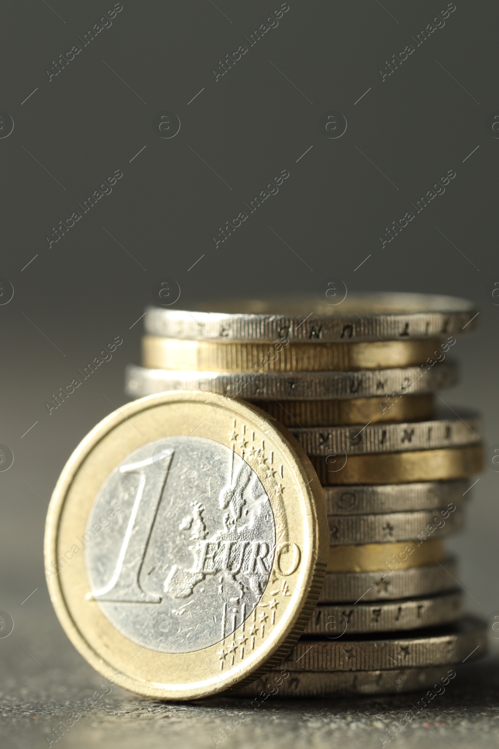 Photo of Many euro coins on grey table, closeup