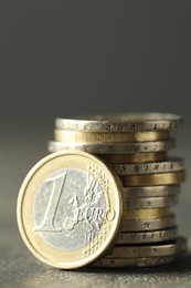 Many euro coins on grey table, closeup