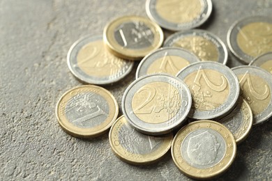 Photo of Many euro coins on grey table, closeup