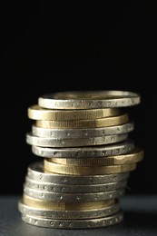 Stacked euro coins on grey table, closeup