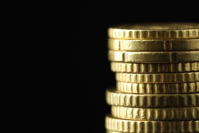 Photo of Stacked euro coins on black background, closeup. Space for text