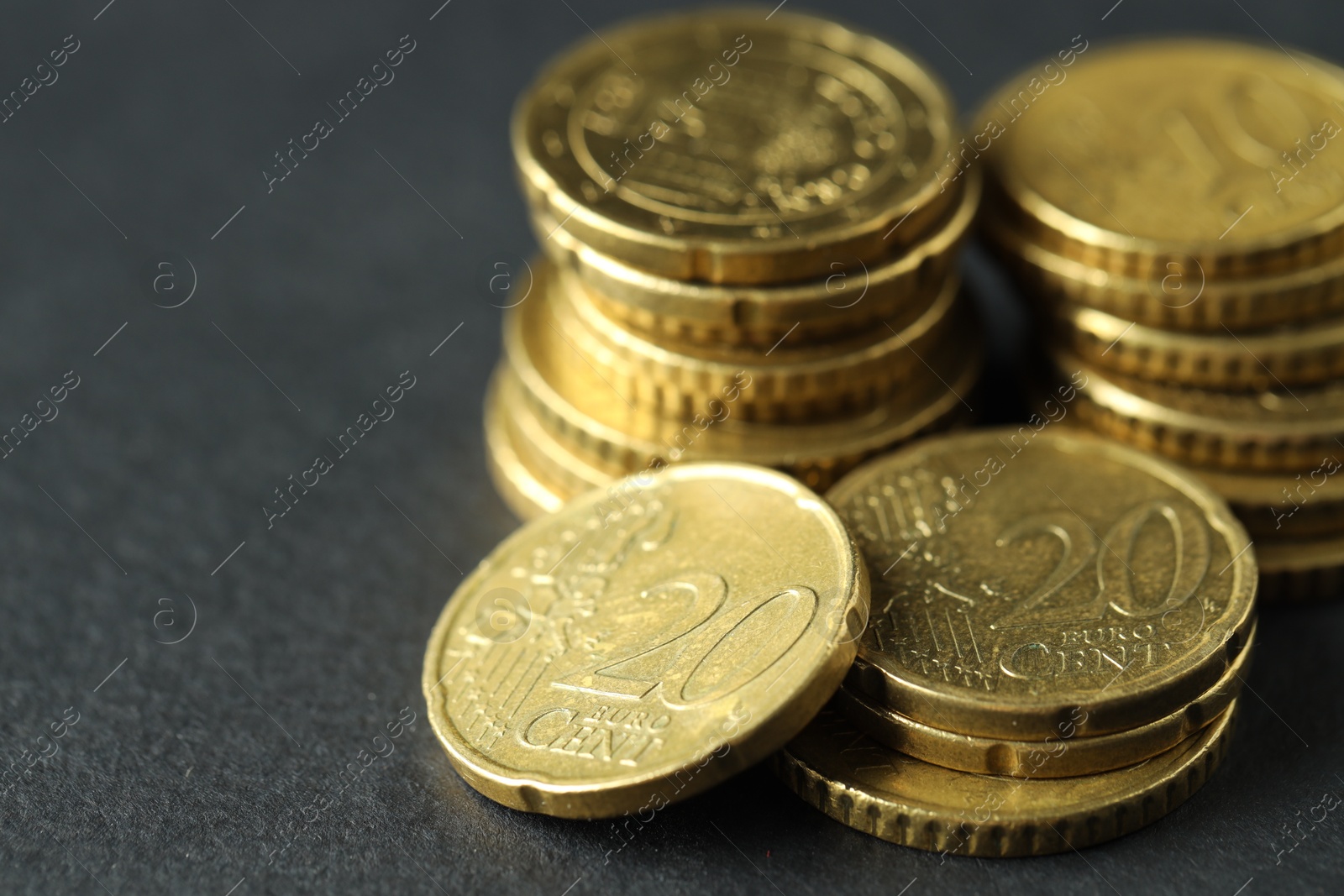 Photo of Many euro coins on grey table, closeup. Space for text