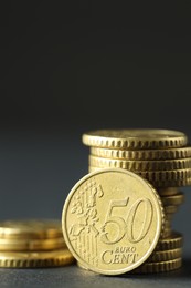 Stacked euro coins on grey table, closeup