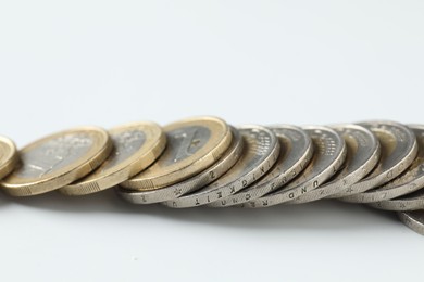 Photo of Many euro coins on white background, closeup