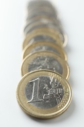 Photo of Many euro coins on white background, closeup