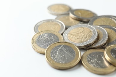 Photo of Many euro coins on white background, closeup