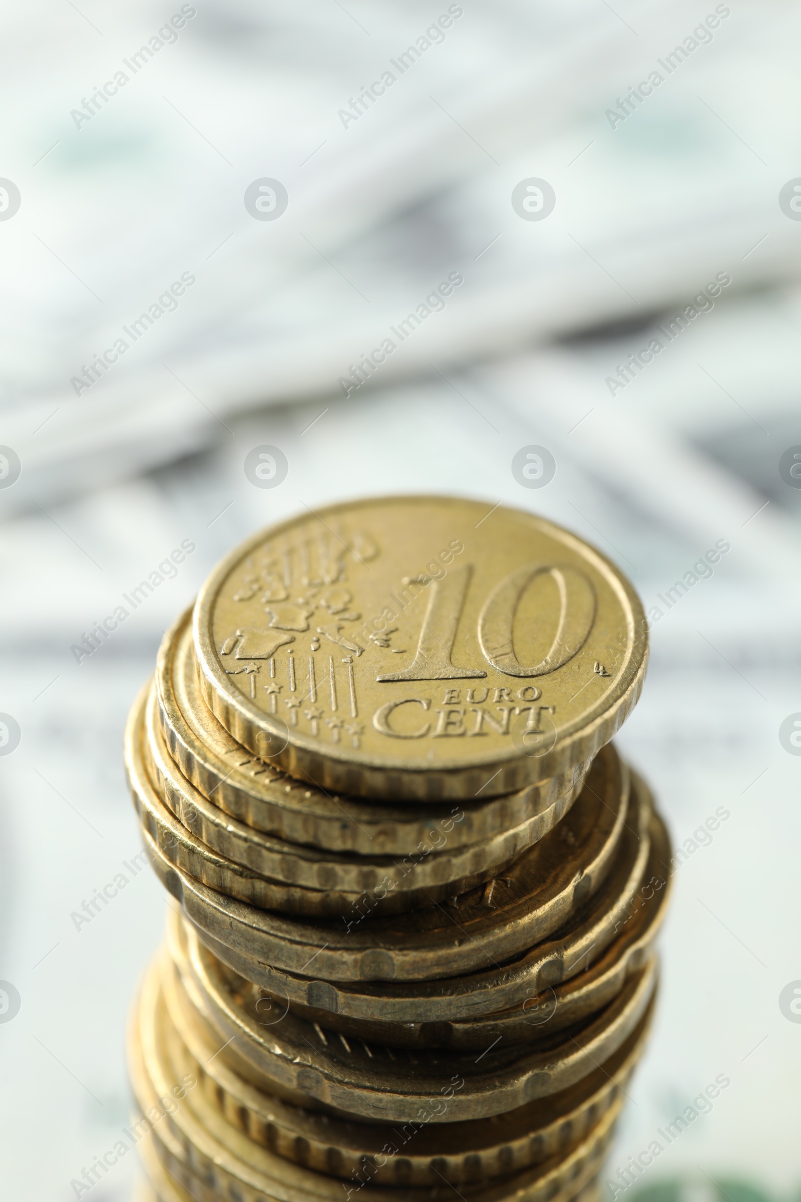 Photo of Stacked euro coins on blurred background, closeup