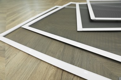 Photo of Set of window screens on wooden floor