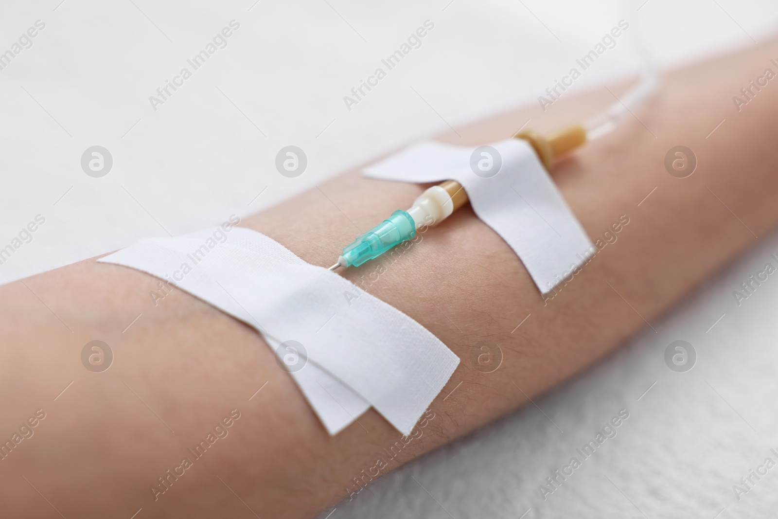 Photo of Woman with intravenous drip in hospital bed, closeup